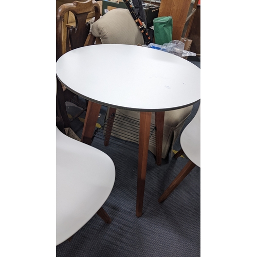 320 - A modern circular topped table with an under-tier below, 75cm h x 67.5cm w, together with two matchi... 
