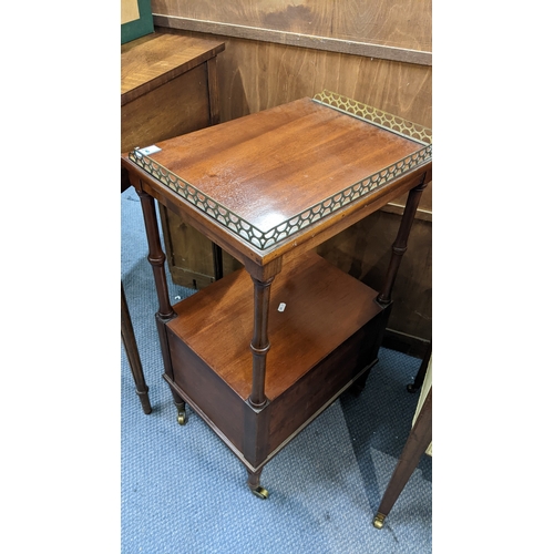 9 - A reproduction mahogany two tier bedside table having a pierced gallery top and two drawers below, 7... 