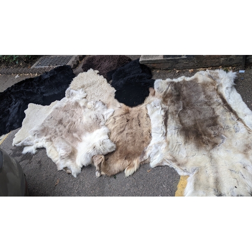 201 - A collection of eight faux fur/animal skin rugs, the largest 126 x 186cm, smallest 88 x 58cm Locatio... 