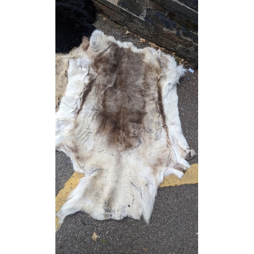 201 - A collection of eight faux fur/animal skin rugs, the largest 126 x 186cm, smallest 88 x 58cm Locatio... 