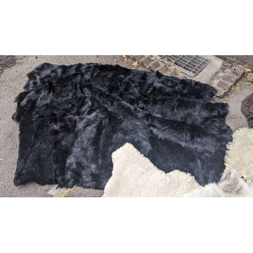 201 - A collection of eight faux fur/animal skin rugs, the largest 126 x 186cm, smallest 88 x 58cm Locatio... 