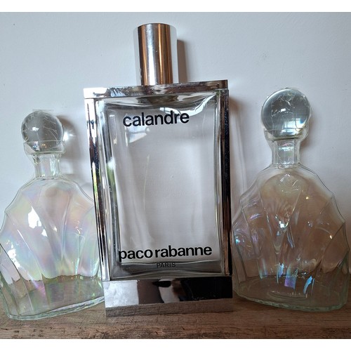 53 - A collection of glass scent bottles to include a large Paco Rabanne Calandre fatice bottle 34cm high... 