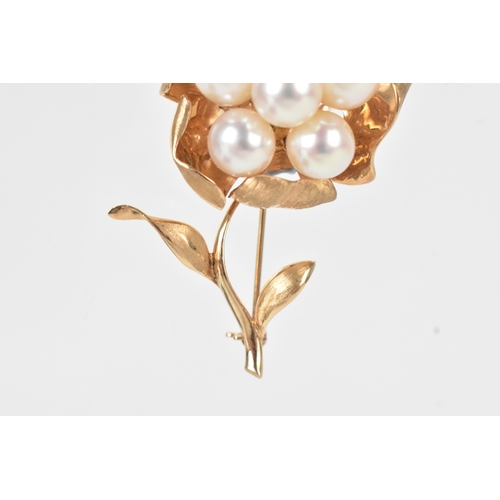 58 - A 14ct gold pearl floral brooch, modelled as a stylised flower set with six round pearls to a textur... 