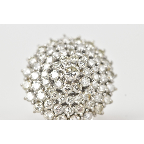 60 - An 18ct white gold diamond cluster ring, the circular head set with a central diamond measuring appr... 