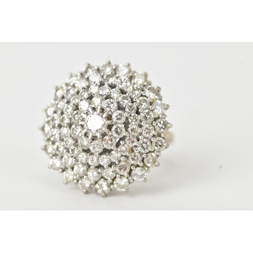 60 - An 18ct white gold diamond cluster ring, the circular head set with a central diamond measuring appr... 