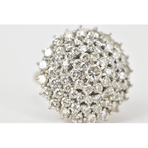 60 - An 18ct white gold diamond cluster ring, the circular head set with a central diamond measuring appr... 