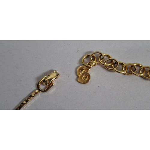 2 - Christian Dior- A 1980's gold tone necklace having a pentagon pendant with inset white rhinestones s... 