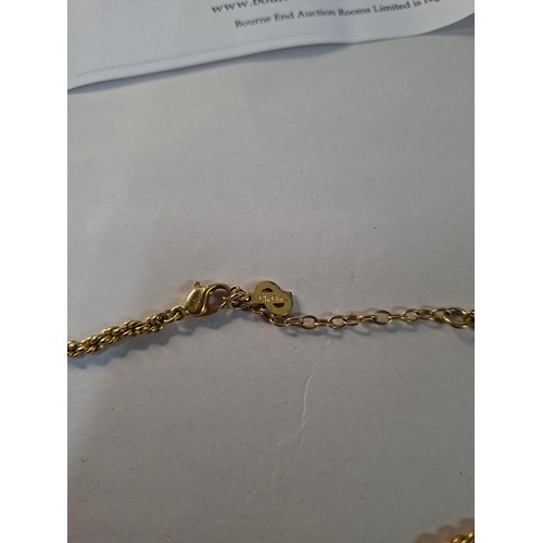 3 - Christian Dior- A 1980's gold tone necklace having a plaited pendant, rope twist chain and CD charm ... 