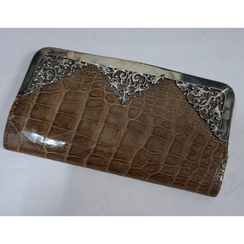 63 - A Victorian tan snakeskin purse with ornate silver frame and clasp 14cm x 7cm. Location:CAB
If there... 