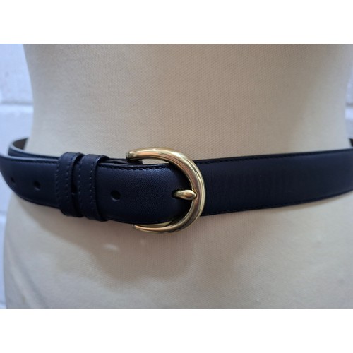 33 - Coach- A ladies black leather belt having a brass buckle, size Medium stamped to the inner belt (UK1... 
