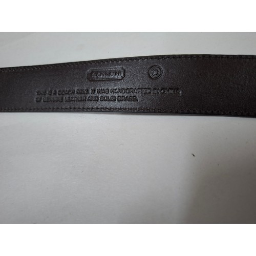 33 - Coach- A ladies black leather belt having a brass buckle, size Medium stamped to the inner belt (UK1... 