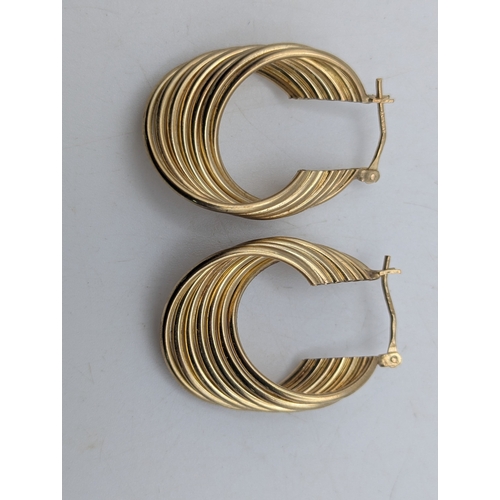 1 - A pair of 9ct yellow gold half hoop spiral earrings stamped 375. weight 4.7g
Location:C8
If there is... 