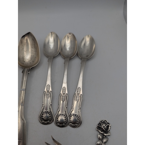 40 - George III silver flatware and cutlery to include a fiddle pattern spoon with a family crest to the ... 
