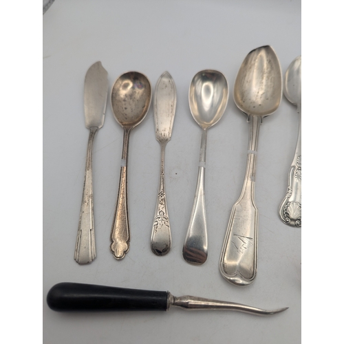 40 - George III silver flatware and cutlery to include a fiddle pattern spoon with a family crest to the ... 