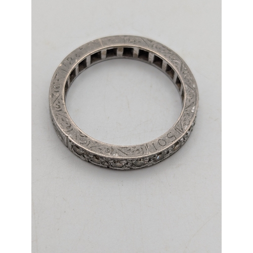 6 - A white metal half eternity diamond ring tested as platinum featuring 10 brilliant cut grain set dia... 
