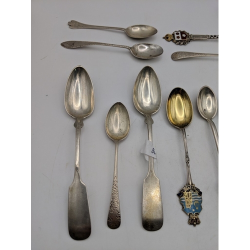 51 - A collection of silver souvenir spoons to include golfing examples and other spoons labelled Scarbor... 