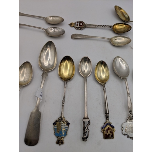 51 - A collection of silver souvenir spoons to include golfing examples and other spoons labelled Scarbor... 
