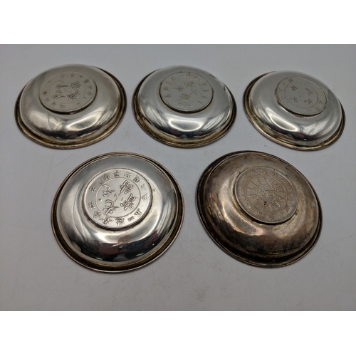 58 - Five Chinese sterling silver coin/pin dishes featuring a dragon motif to the centre, 219.g
Location:... 
