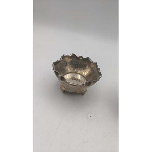 61 - A pair of Victorian silver salts and a spoon hallmarked London 1882 weighing a total of 83g
Location... 