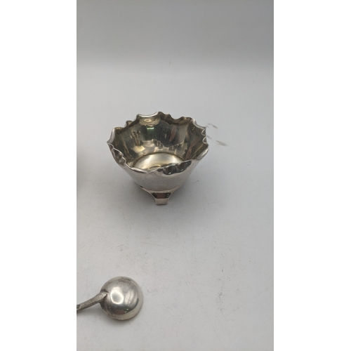 61 - A pair of Victorian silver salts and a spoon hallmarked London 1882 weighing a total of 83g
Location... 
