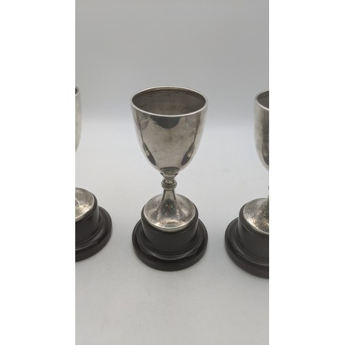 57 - Three silver trophy cups hallmarked Birmingham 1937 weighing a total of 108.9g on weighted plinths
L... 