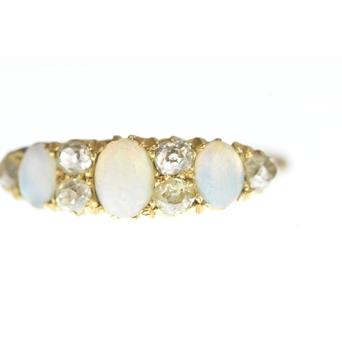1 - A Victorian diamond and opal 18ct yellow gold ring, set with three graduated oval cabochon-cut opals... 
