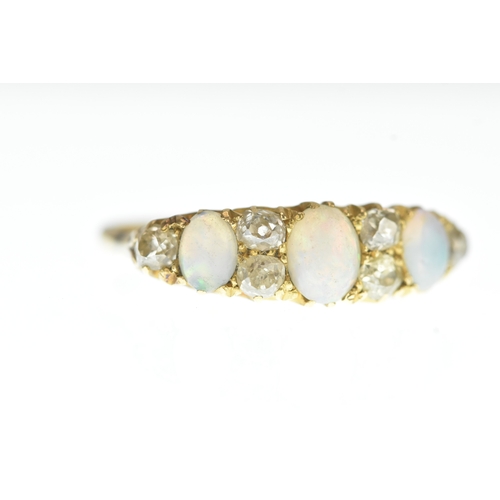 1 - A Victorian diamond and opal 18ct yellow gold ring, set with three graduated oval cabochon-cut opals... 