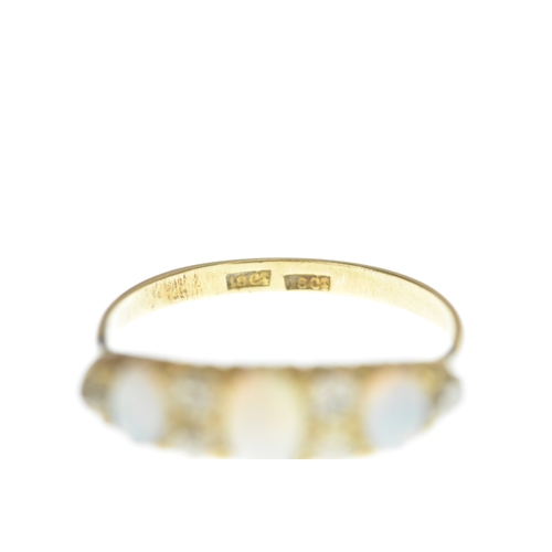 1 - A Victorian diamond and opal 18ct yellow gold ring, set with three graduated oval cabochon-cut opals... 