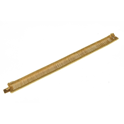 12 - A 18ct yellow gold bracelet, with a series of articulated curved and ribbed links, having a box and ... 