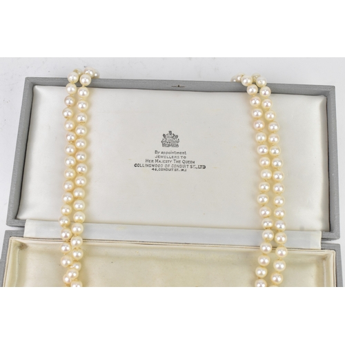 13 - A double strand pearl necklace, having a yellow and white metal diamond cluster set marquise shape b... 