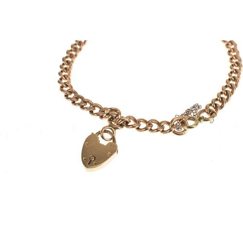 14 - A 9ct rose gold curb link bracelet with a rose coloured padlock charm having a 9ct yellow gold sprin... 