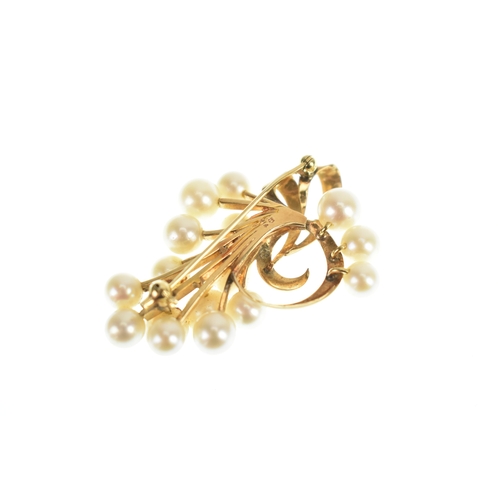 15 - A Mikimoto 14k yellow gold and cultured pearl spray brooch, featuring a cluster of 16 pearls in a fl... 