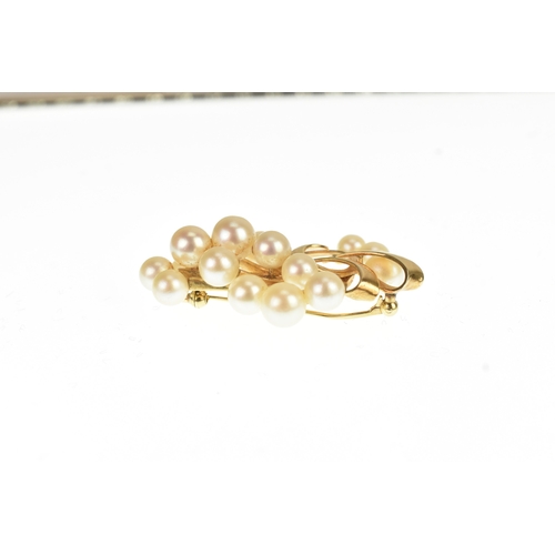 15 - A Mikimoto 14k yellow gold and cultured pearl spray brooch, featuring a cluster of 16 pearls in a fl... 