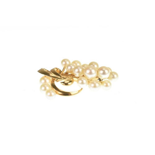 15 - A Mikimoto 14k yellow gold and cultured pearl spray brooch, featuring a cluster of 16 pearls in a fl... 