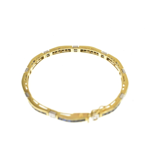 25 - A diamond and blue sapphire 18ct yellow gold tennis bracelet, featuring channel set square-cut blue ... 