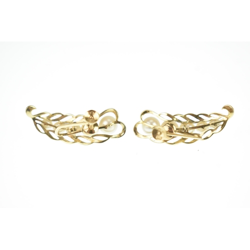 27 - A pair of Mikimoto 14k yellow gold and pearl screw back earrings, in the form of a leaf with pierced... 