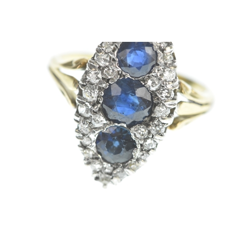 32 - A Victorian diamond and blue sapphire yellow and white metal marquise shaped cluster ring, set with ... 