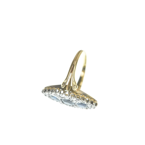 32 - A Victorian diamond and blue sapphire yellow and white metal marquise shaped cluster ring, set with ... 