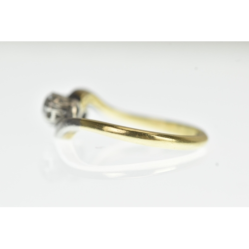 34 - A two stone diamond 18ct yellow gold and platinum crossover ring, with two brilliant cut claw set di... 