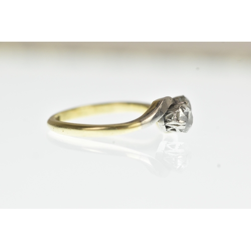 34 - A two stone diamond 18ct yellow gold and platinum crossover ring, with two brilliant cut claw set di... 