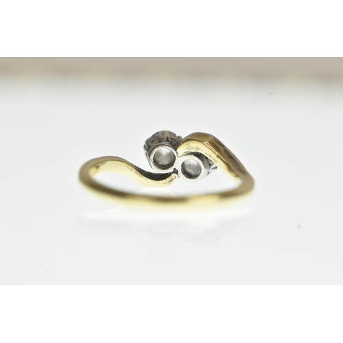 34 - A two stone diamond 18ct yellow gold and platinum crossover ring, with two brilliant cut claw set di... 