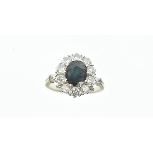 35 - A sapphire and diamond 18ct white cluster ring, with a central oval cut claw set sapphire, surrounde... 