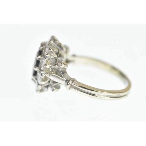 35 - A sapphire and diamond 18ct white cluster ring, with a central oval cut claw set sapphire, surrounde... 
