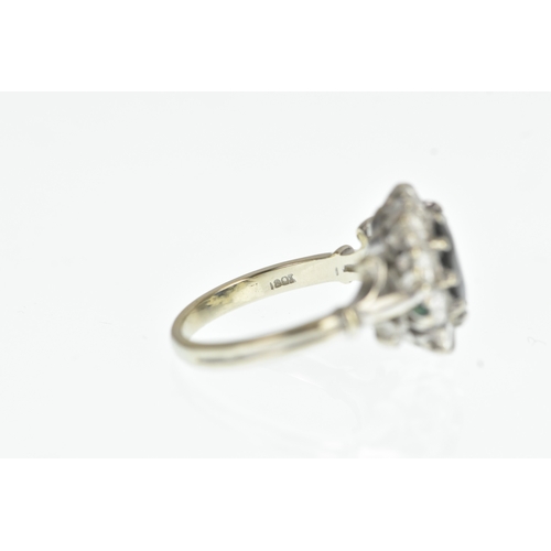 35 - A sapphire and diamond 18ct white cluster ring, with a central oval cut claw set sapphire, surrounde... 