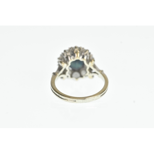 35 - A sapphire and diamond 18ct white cluster ring, with a central oval cut claw set sapphire, surrounde... 