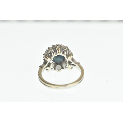 35 - A sapphire and diamond 18ct white cluster ring, with a central oval cut claw set sapphire, surrounde... 