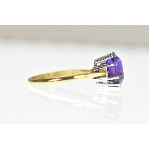 36 - A purple amethyst and diamond 18ct yellow and white gold dress ring, with central oval cut claw set ... 