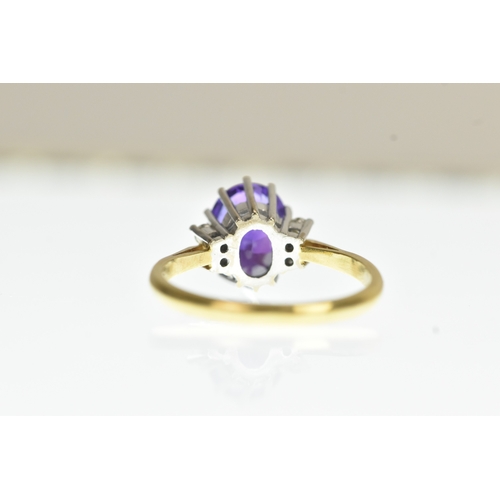 36 - A purple amethyst and diamond 18ct yellow and white gold dress ring, with central oval cut claw set ... 