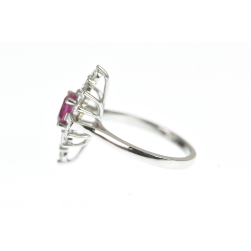 4 - A ruby and diamond and platinum cluster sunburst ring, set with a central oval-cut ruby surrounded b... 