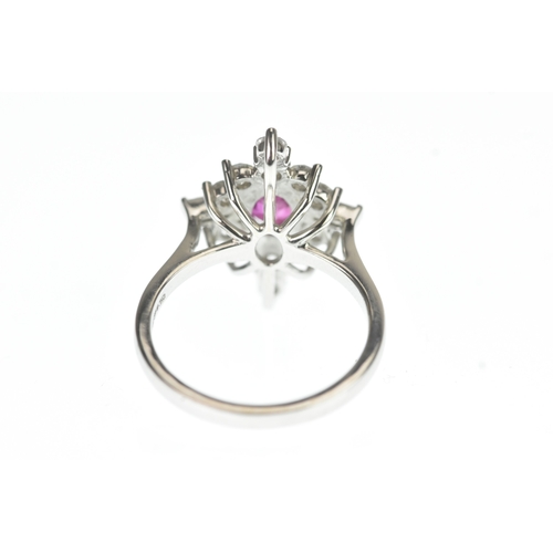 4 - A ruby and diamond and platinum cluster sunburst ring, set with a central oval-cut ruby surrounded b... 